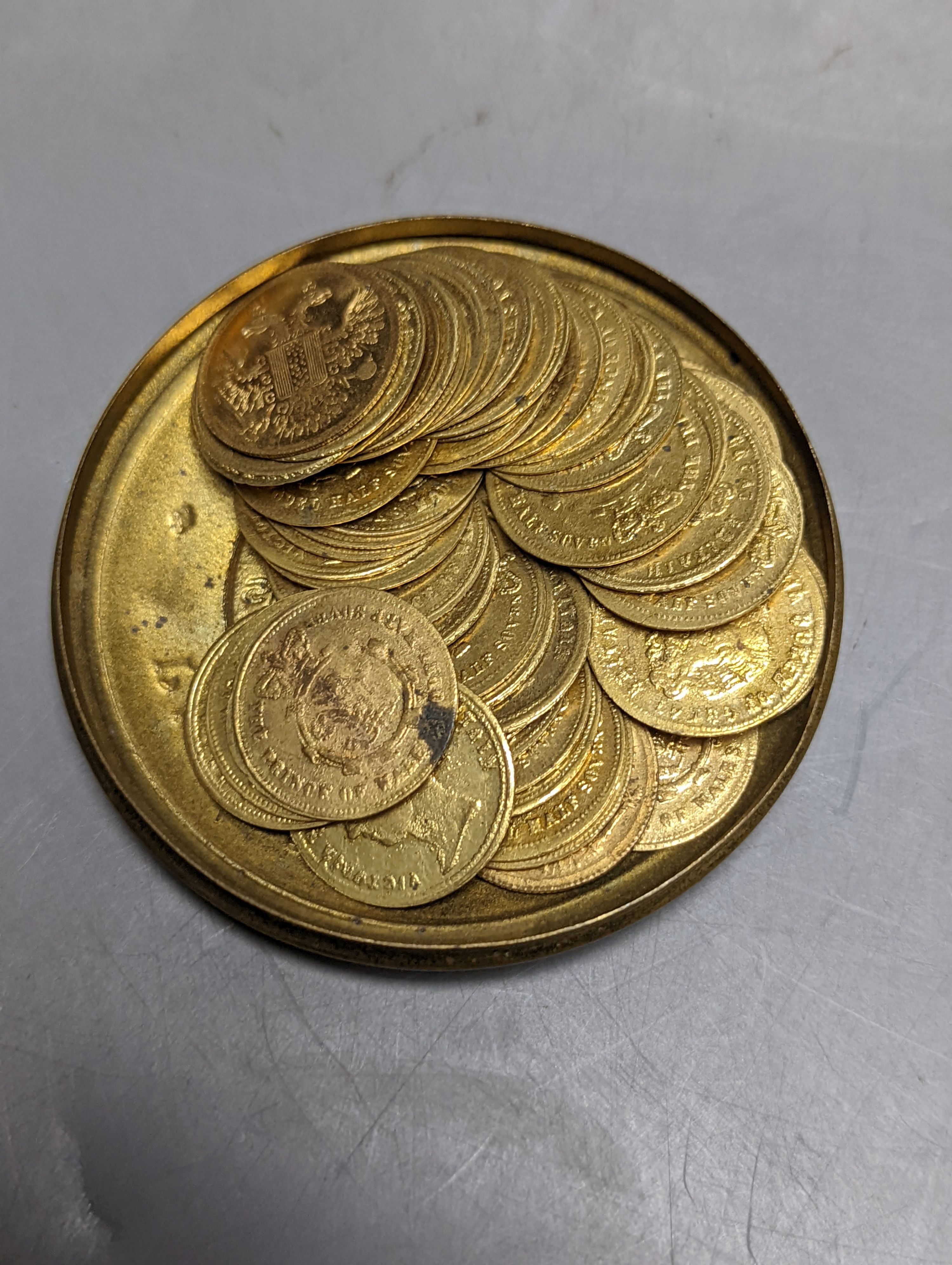 Two Exhibition Prize Medals, to JV Hill, saw manufacturers, London 1851 and Paris 1855, frame 34cm. wide, and a collection of Victorian coin tokens, in Pinches & Co. case, 1857